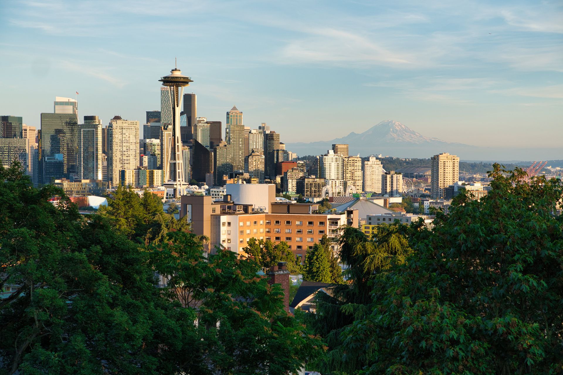 Aerial view of the Seattle skyline featuring the Space Needle, downtown towers, and Puget Sound